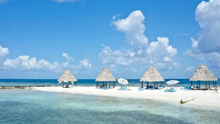 Sunny tropical beach with turquoise waters and clear skies in Belize during the dry season