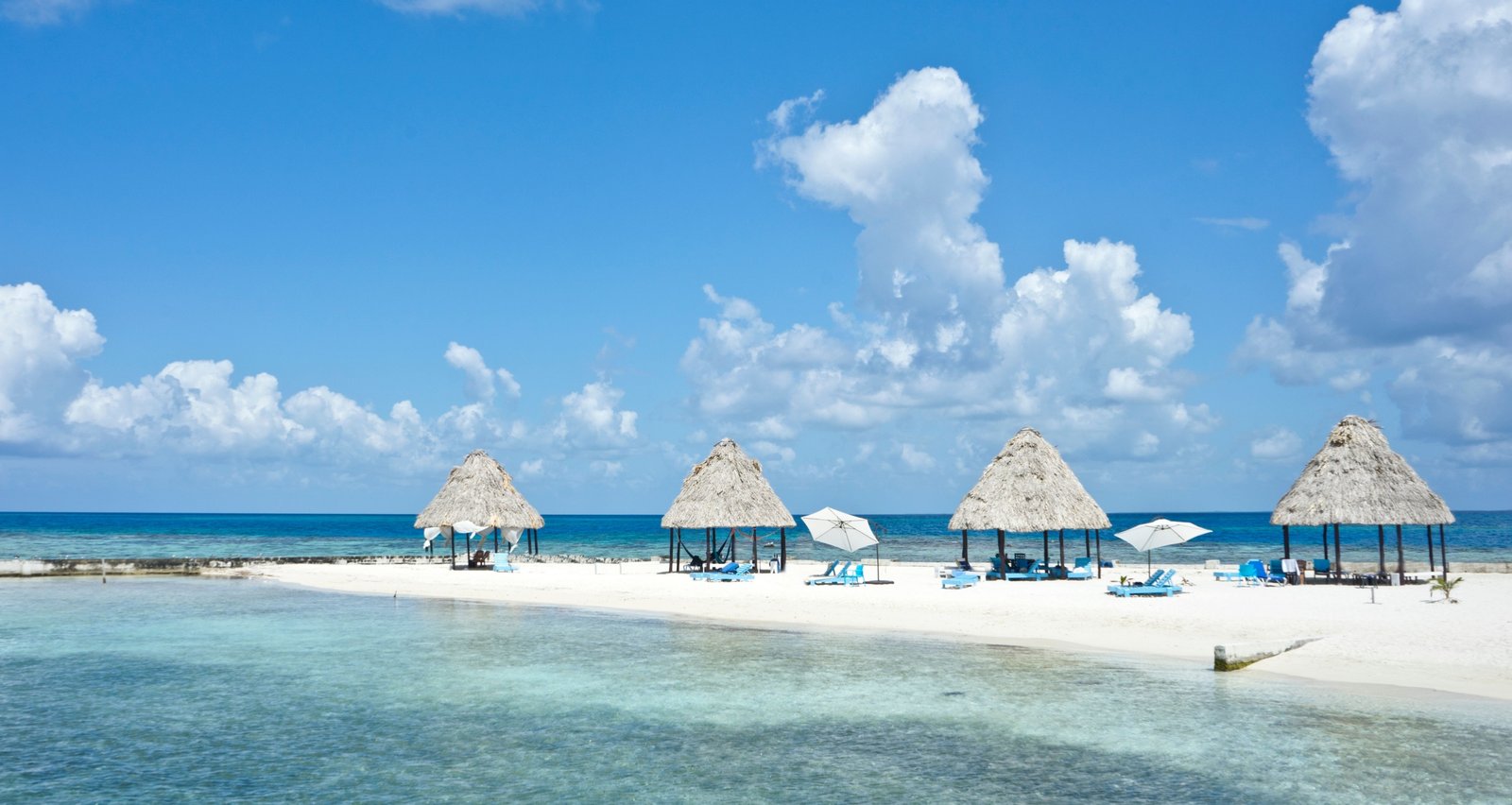 Sunny tropical beach with turquoise waters and clear skies in Belize during the dry season