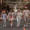 Joyful family enjoying Christmas travel holiday with suitcases and festive decorations, celebrating vacation and holiday deals in 2026
