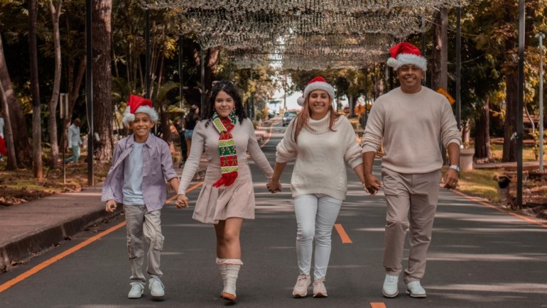 Joyful family enjoying Christmas travel holiday with suitcases and festive decorations, celebrating vacation and holiday deals in 2026