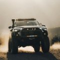 3rd gen Toyota 4Runner with long travel suspension driving on rough off-road trail