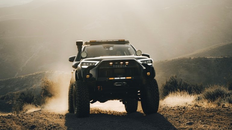3rd gen Toyota 4Runner with long travel suspension driving on rough off-road trail