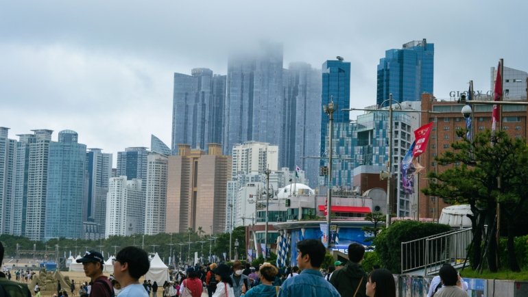 Scenic view of Busan coastline with Haeundae Beach and colorful city skyline, ideal travel destination in South Korea