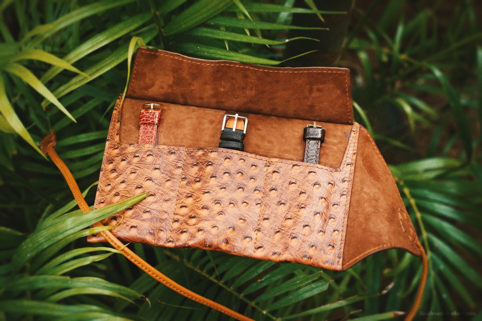 Leather travel watch pouch protecting luxury watches while packed in a travel bag