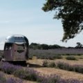 Airstream travel trailer parked outdoors during a road trip, showcasing classic aluminum design and outdoor adventure lifestyle