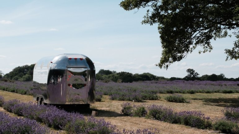 Airstream travel trailer parked outdoors during a road trip, showcasing classic aluminum design and outdoor adventure lifestyle