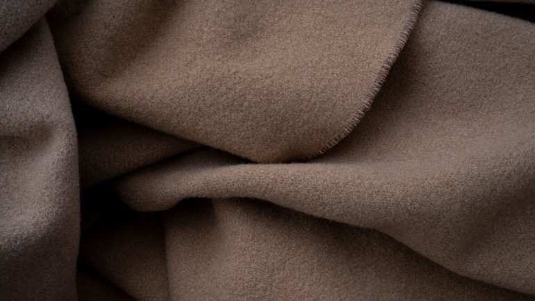 Elegant cashmere travel blanket providing warmth and comfort on a stylish journey