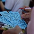 Group of happy travelers playing bingo on a cruise ship enjoying social travel entertainment