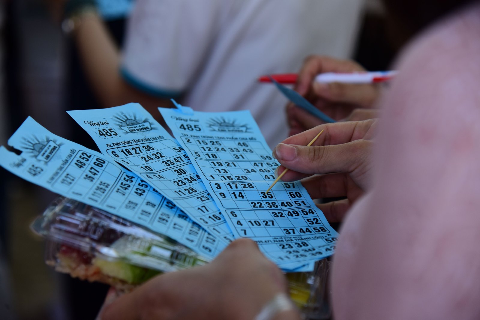 Group of happy travelers playing bingo on a cruise ship enjoying social travel entertainment