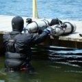 Scuba diver packing lightweight and compact travel BCD for dive trip preparation