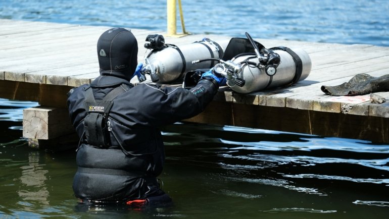 Scuba diver packing lightweight and compact travel BCD for dive trip preparation
