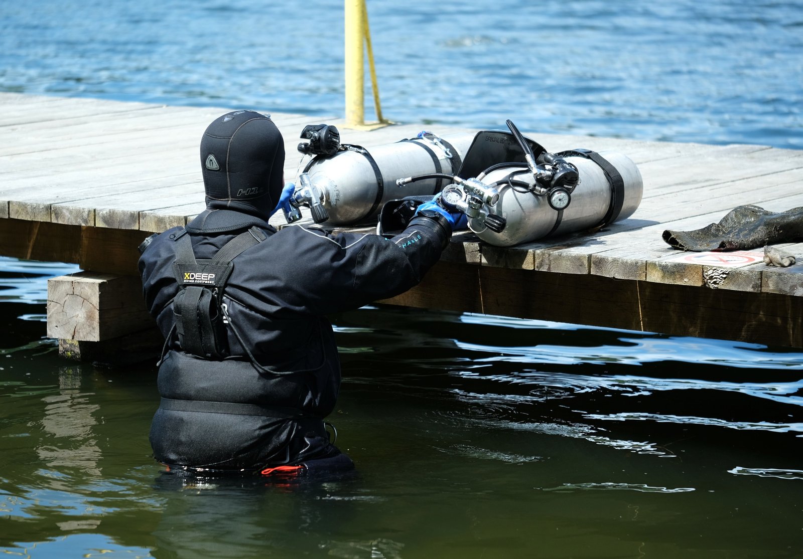 Scuba diver packing lightweight and compact travel BCD for dive trip preparation