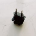 Travel adapter plugged into Brazil Type N electrical outlet ensuring safe device charging during Brazil trip