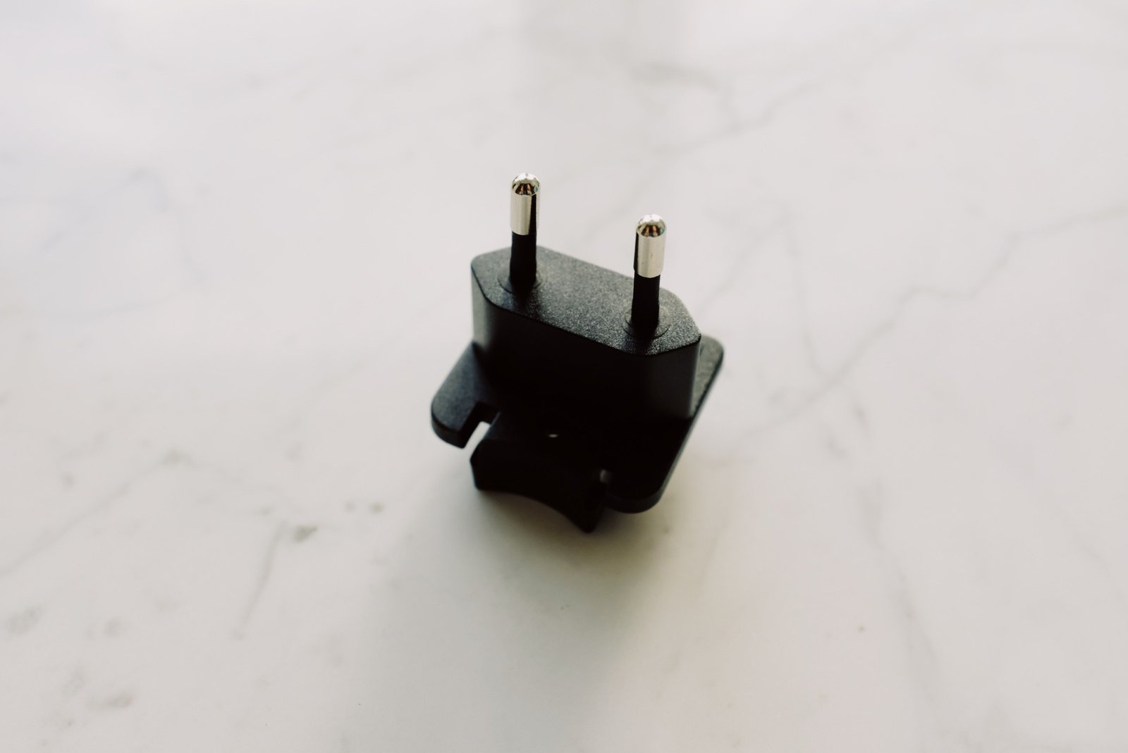 Travel adapter plugged into Brazil Type N electrical outlet ensuring safe device charging during Brazil trip