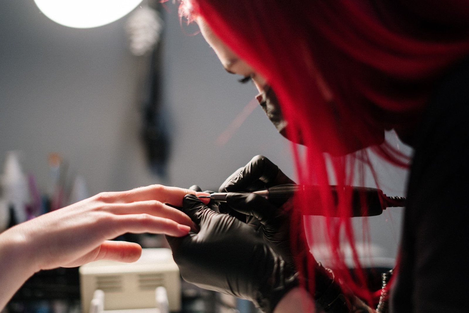 Mobile nail technician giving a professional manicure in a home setting, showcasing convenient and personalized nail care services