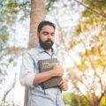 Traveler holding a Bible outdoors symbolizing spiritual protection and peace during travel