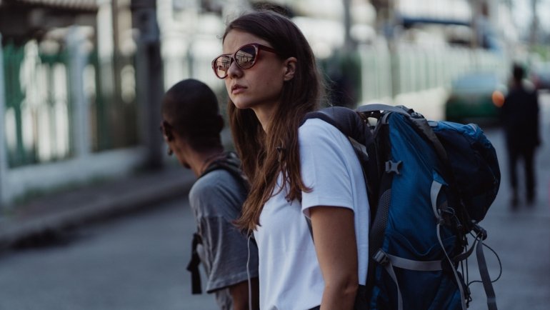Traveler wearing a lightweight 25-liter backpack walking in city with organized gear for day travel
