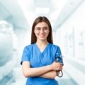 Young female travel nurse in hospital smiling while starting her new nursing career on assignment