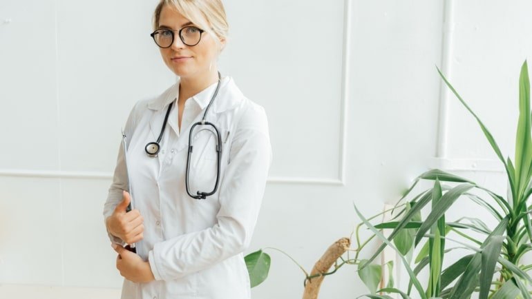 Allied health professional working in a clinical setting with travel gear, representing travel allied health jobs and career flexibility