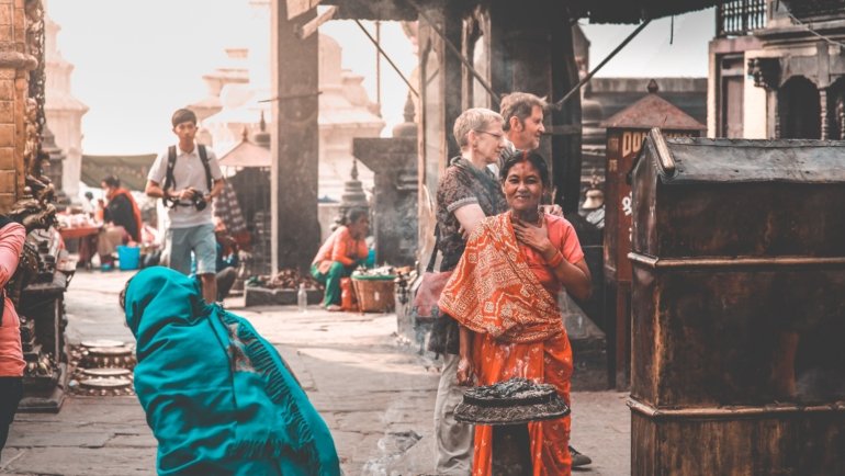 Respectful traveler interacting with locals while exploring cultural traditions responsibly