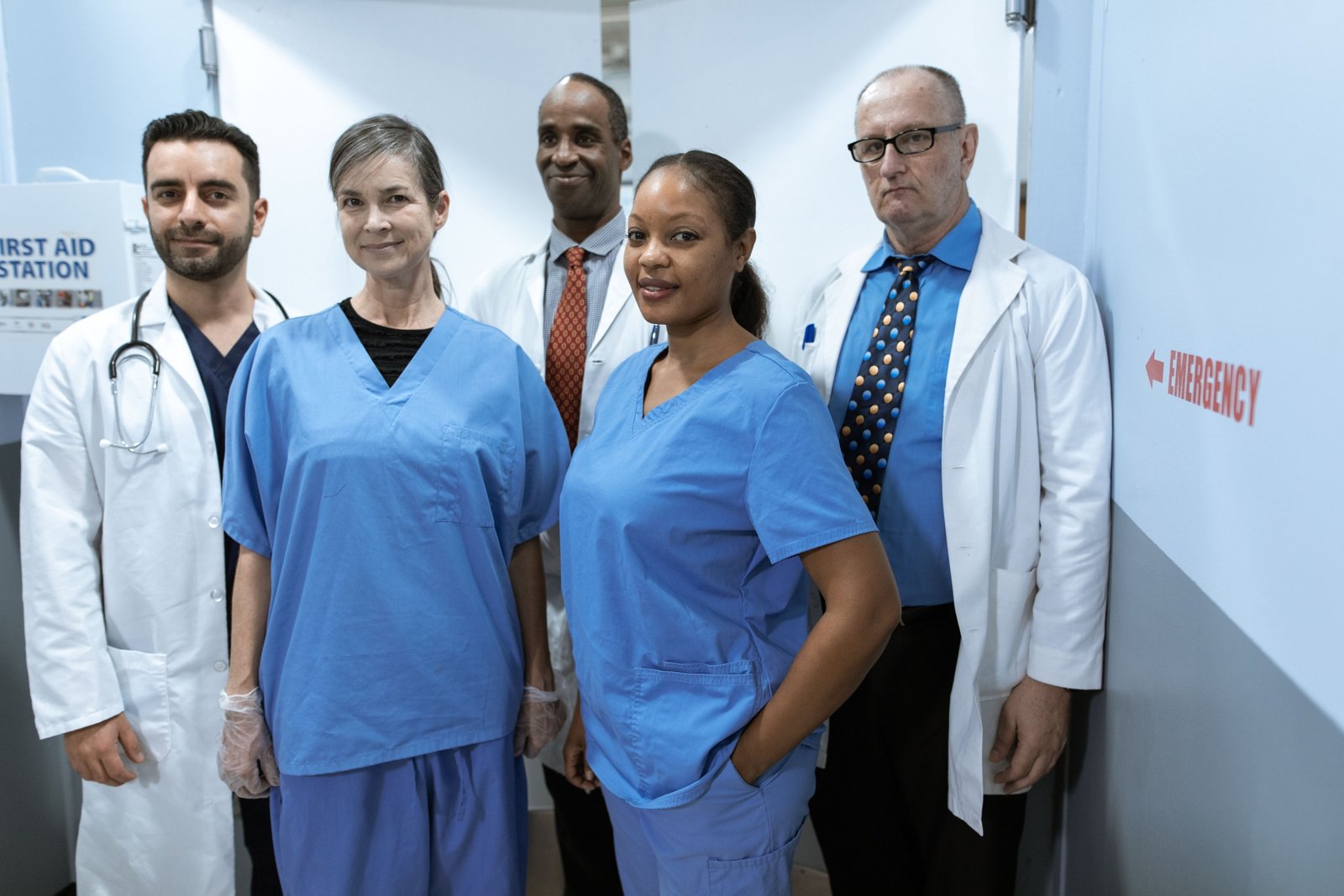 Cardiovascular travel nurse assisting with cardiac catheterization procedure in hospital cath lab