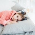 Toddler peacefully sleeping in a portable travel bed showing comfort, safety, and convenience for travel