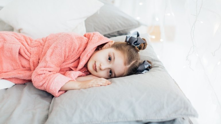 Toddler peacefully sleeping in a portable travel bed showing comfort, safety, and convenience for travel