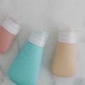 Travel toiletry bag filled with multiple travel size body wash bottles for convenient and space-saving packing