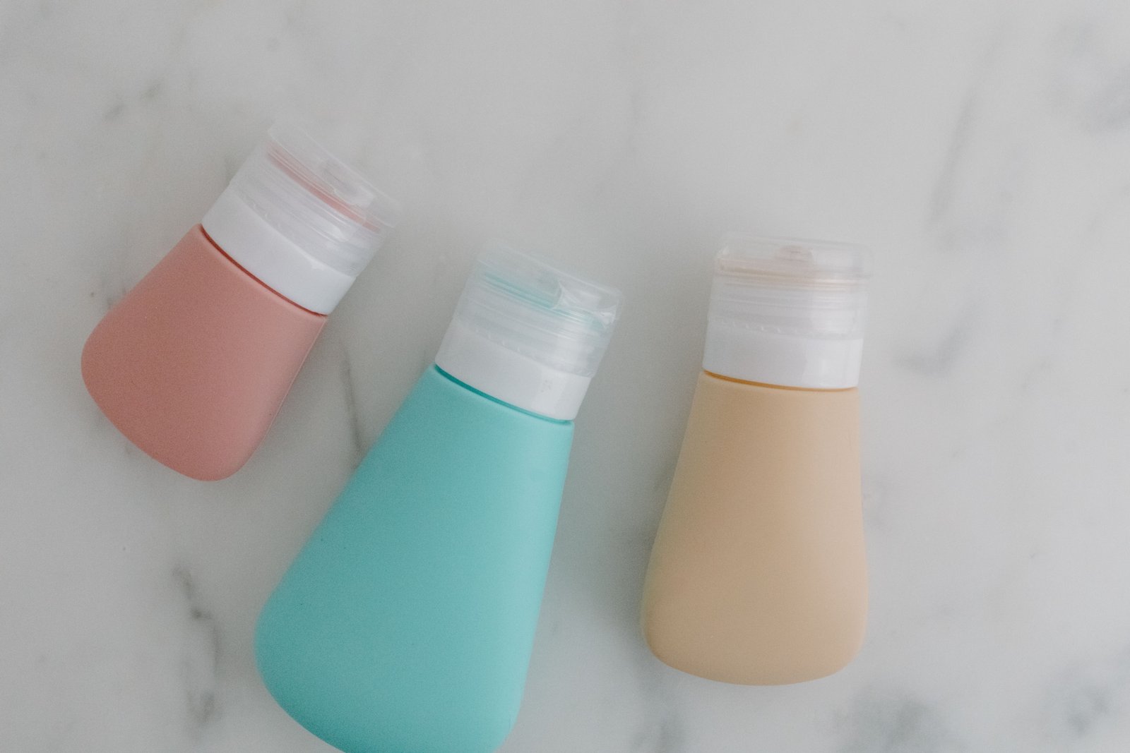 Travel toiletry bag filled with multiple travel size body wash bottles for convenient and space-saving packing
