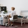 Cardiac sonographer performing echocardiogram in hospital, showcasing healthcare travel job experience