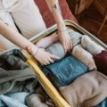 Close-up of clothes packed neatly in a suitcase, illustrating the potential for bed bugs to travel on clothing during travel