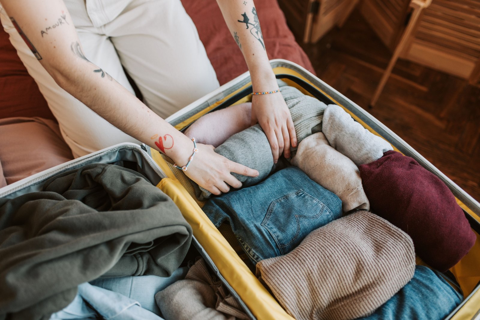 Close-up of clothes packed neatly in a suitcase, illustrating the potential for bed bugs to travel on clothing during travel