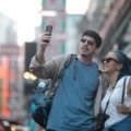 Traveler confidently using smartphone abroad with travel insurance assistance for safety and emergency support
