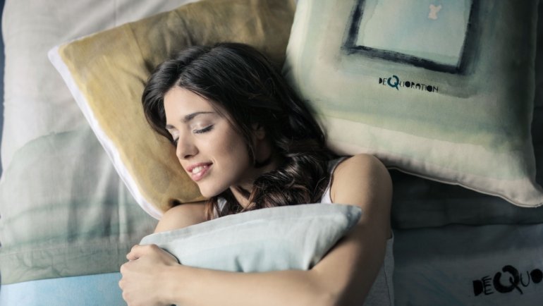 Traveler resting comfortably with a soft goose down travel pillow supporting neck during flight
