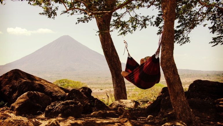 Sunny beach in Nicaragua with volcano in the background during dry season, perfect for travel and outdoor activities