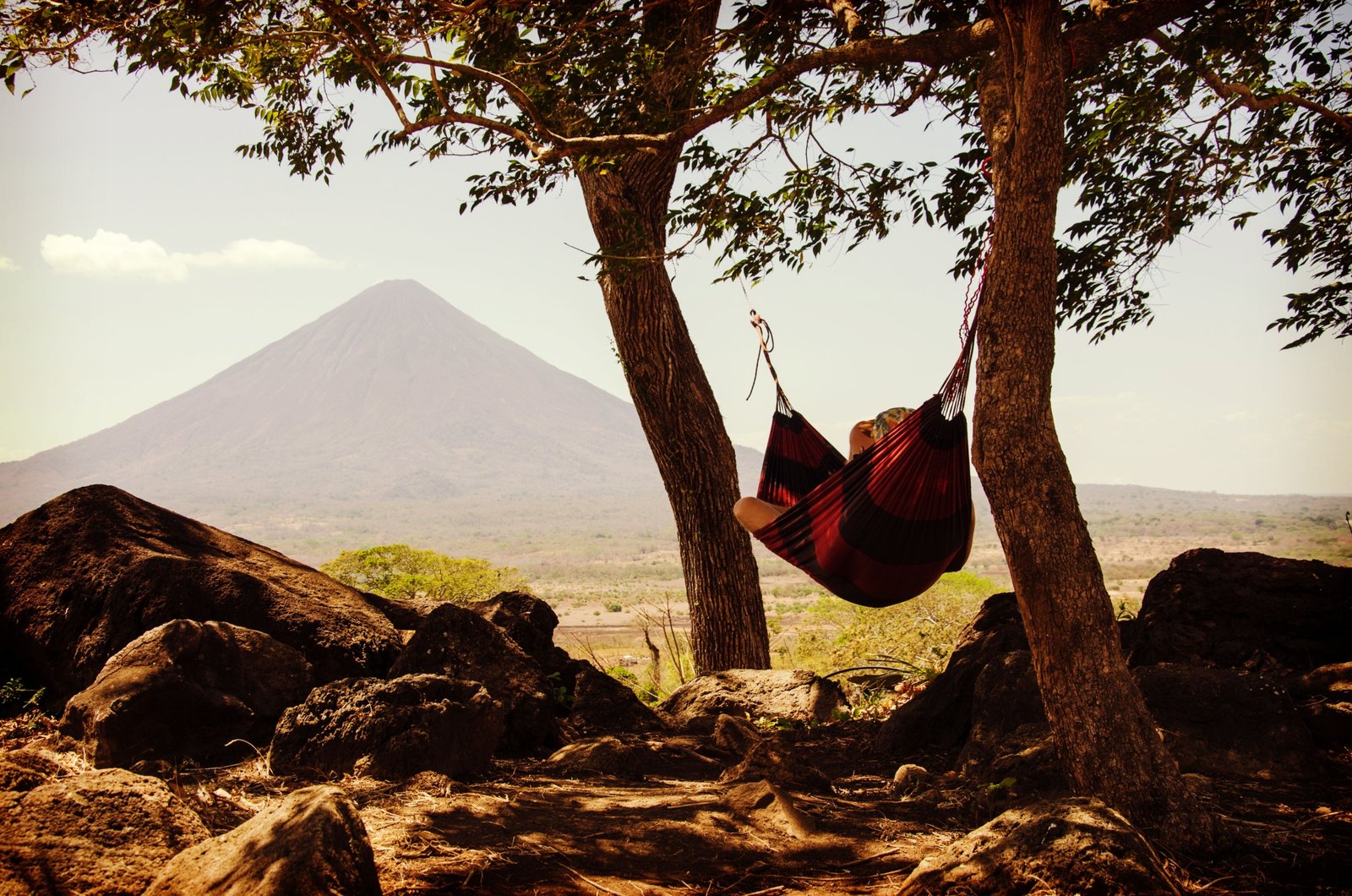Sunny beach in Nicaragua with volcano in the background during dry season, perfect for travel and outdoor activities