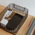 Organized travel tray with passport, phone, chargers, and snacks for easy access during airport security check
