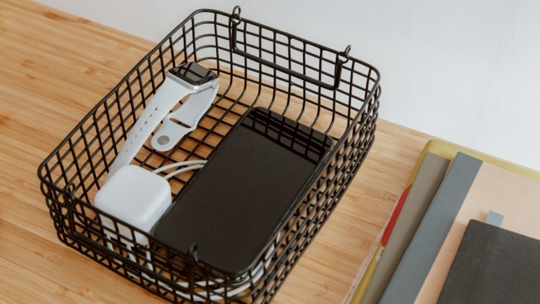 Organized travel tray with passport, phone, chargers, and snacks for easy access during airport security check