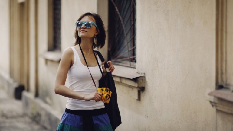 Durable stylish travel sunglasses with UV protection worn outdoors by traveler