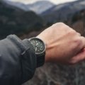 Traveler wearing a durable and stylish travel watch outdoors in nature