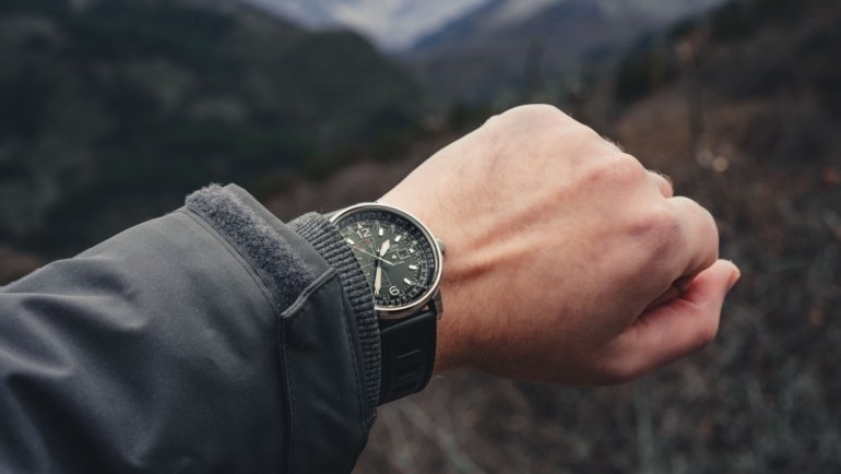 Traveler wearing a durable and stylish travel watch outdoors in nature