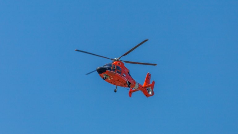 Helicopter flying fast in clear sky representing speed and advanced aviation technology