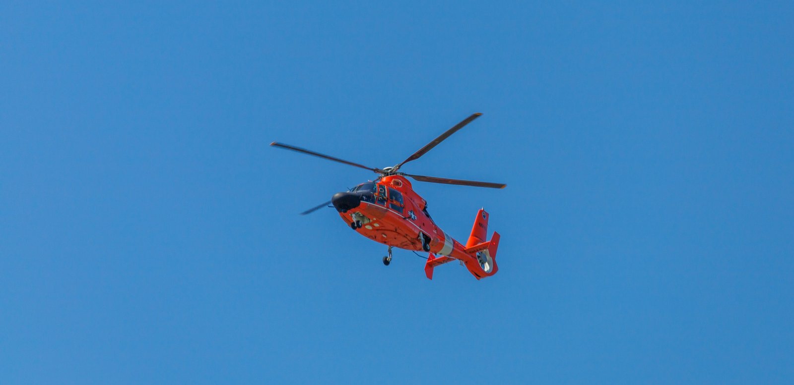 Helicopter flying fast in clear sky representing speed and advanced aviation technology