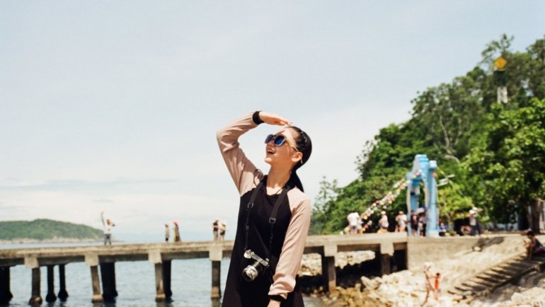 Woman wearing a comfortable and stylish travel dress with sleeves outdoors, combining elegance and practicality for travel