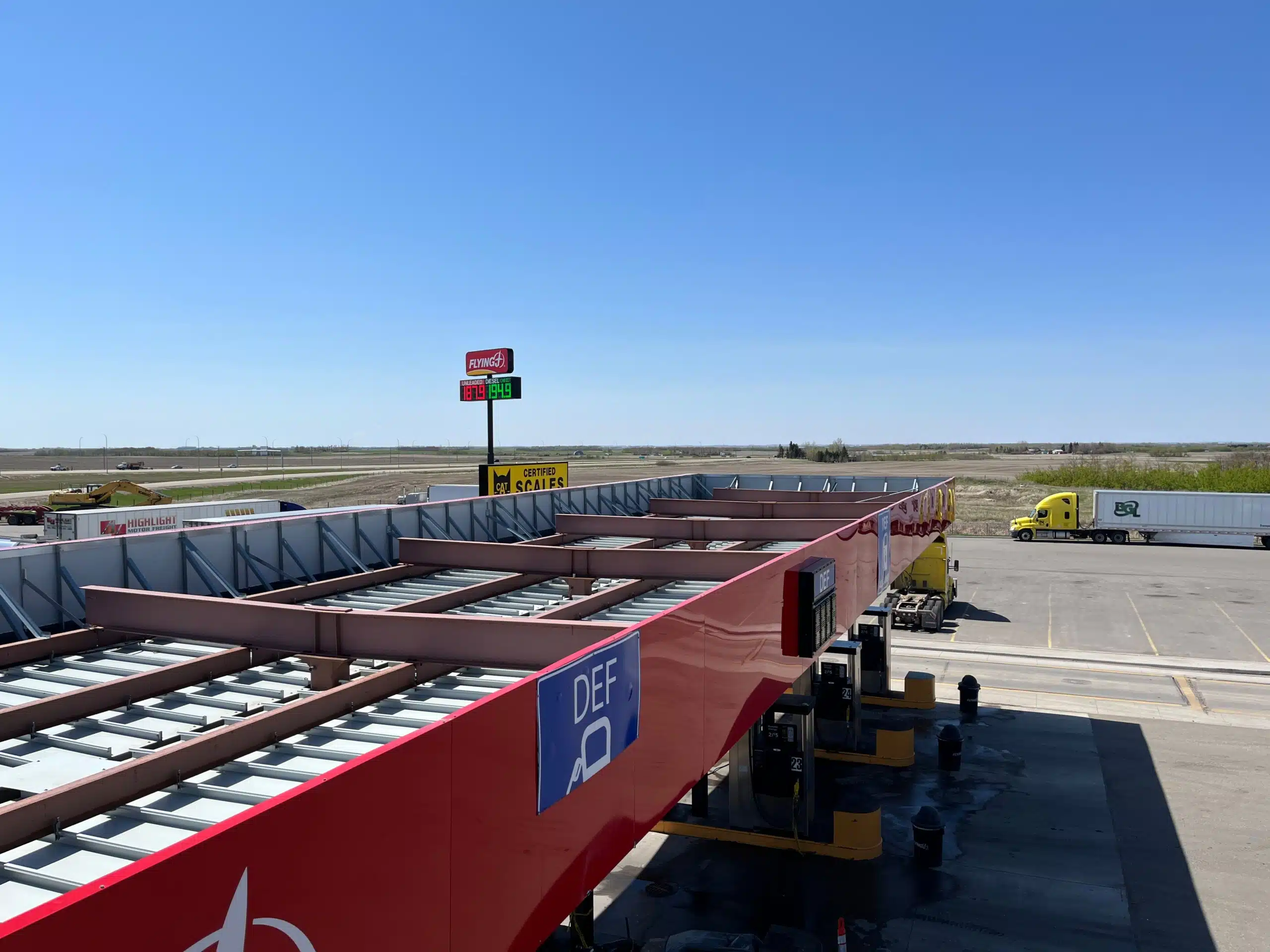 Lamar Travel Plaza highway rest stop with fuel station, parking, and travelers resting during a road trip