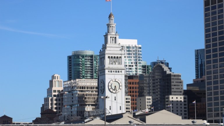San Francisco tourism board meeting with city landmarks in the background, symbolizing leadership and strategic tourism planning in 2014