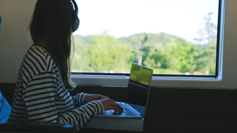 Remote work in travel technology with laptop and digital tools outdoors