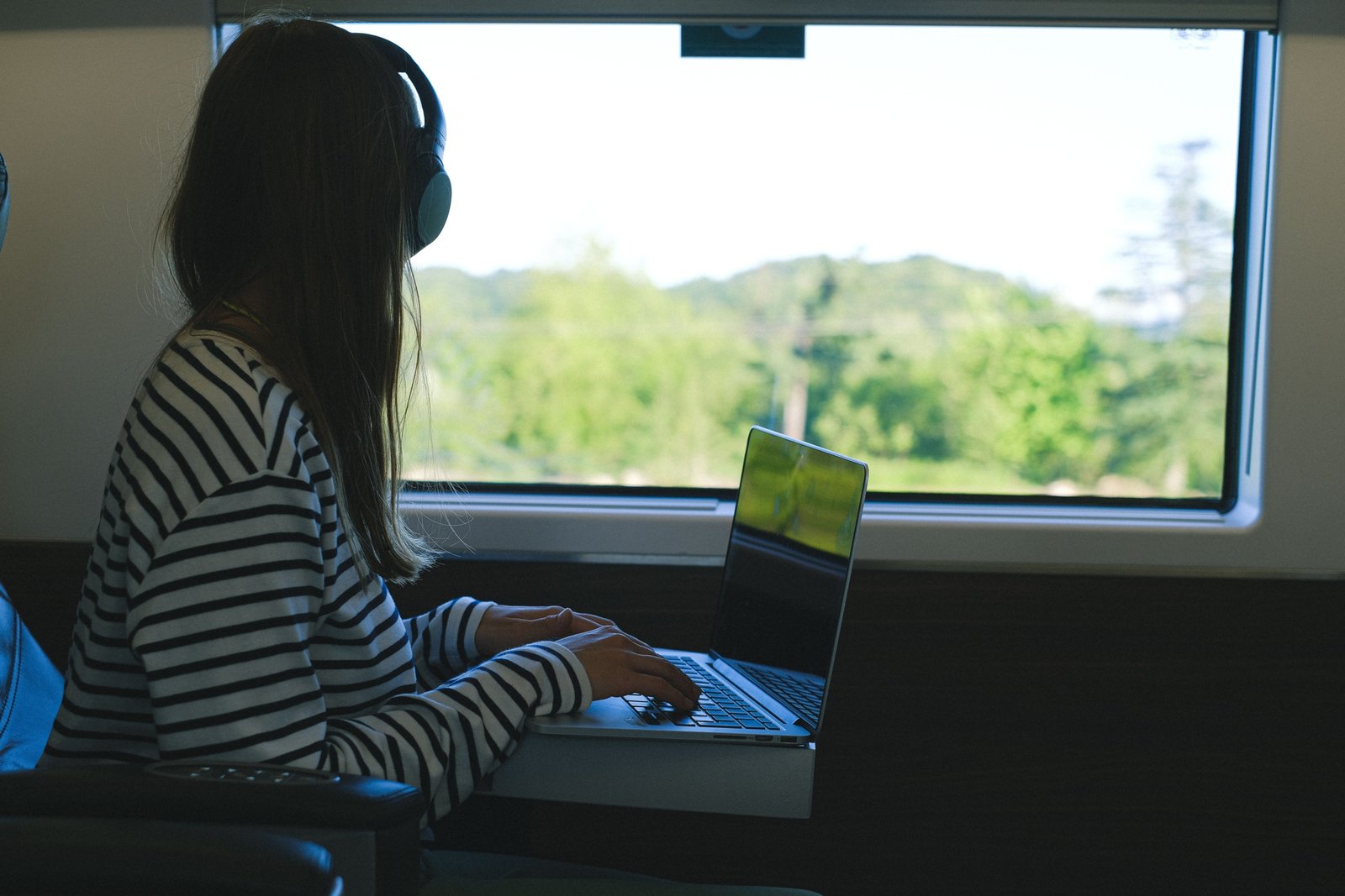 Remote work in travel technology with laptop and digital tools outdoors
