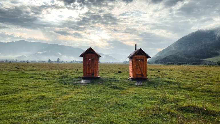 Portable camping toilet in natural outdoor setting for hygienic travel and adventure