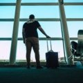 Durable 25 inch travel suitcase with smooth wheels in airport, ideal for organized and convenient travel